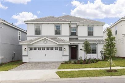 a large white building with a view of a yard in front of it