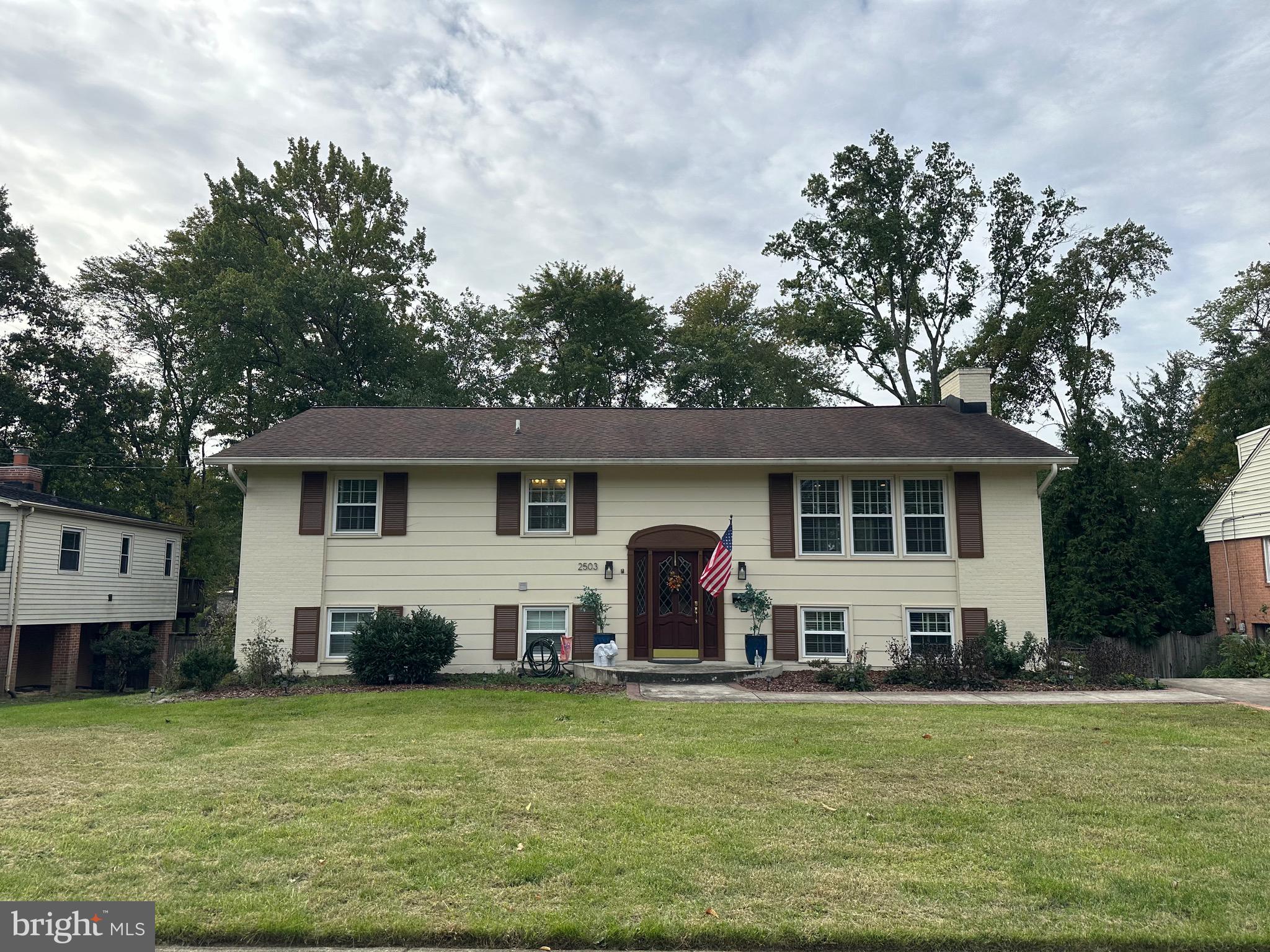 a front view of a house with a garden