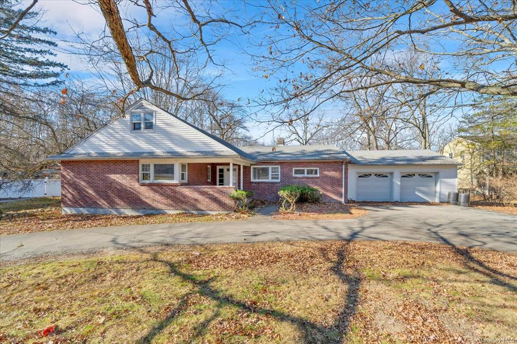 Ranch-style home with a garage and a front lawn