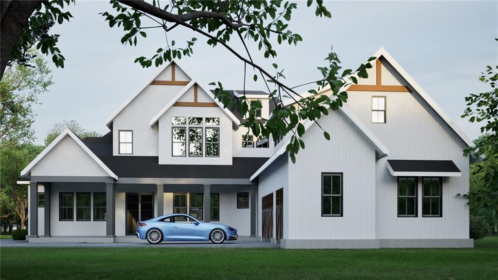 a front view of a house with a garden and garage