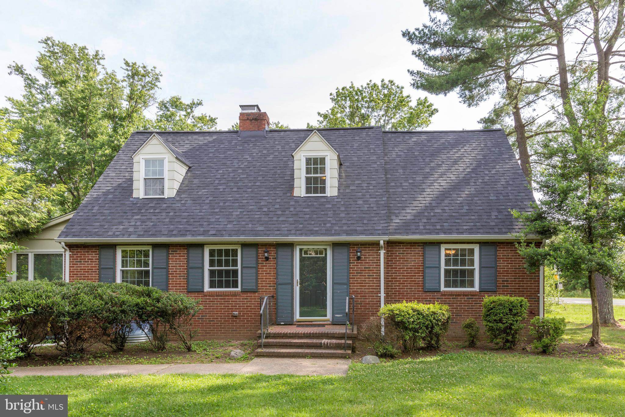 a front view of a house with garden and porch