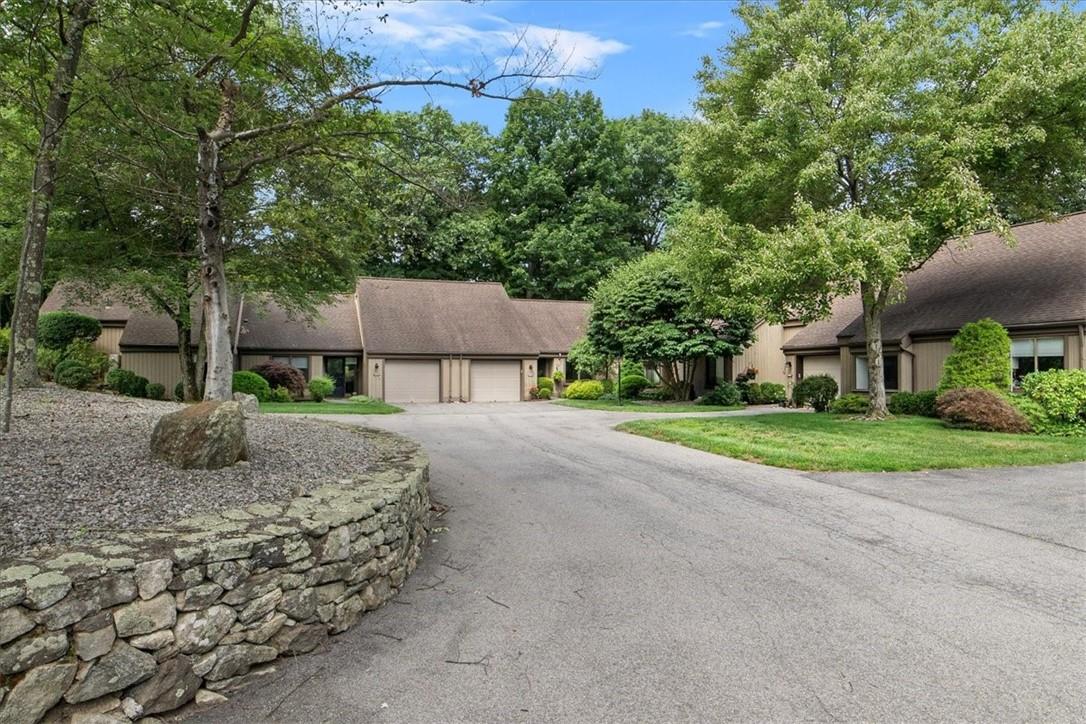 a front view of a house with a yard and a garage