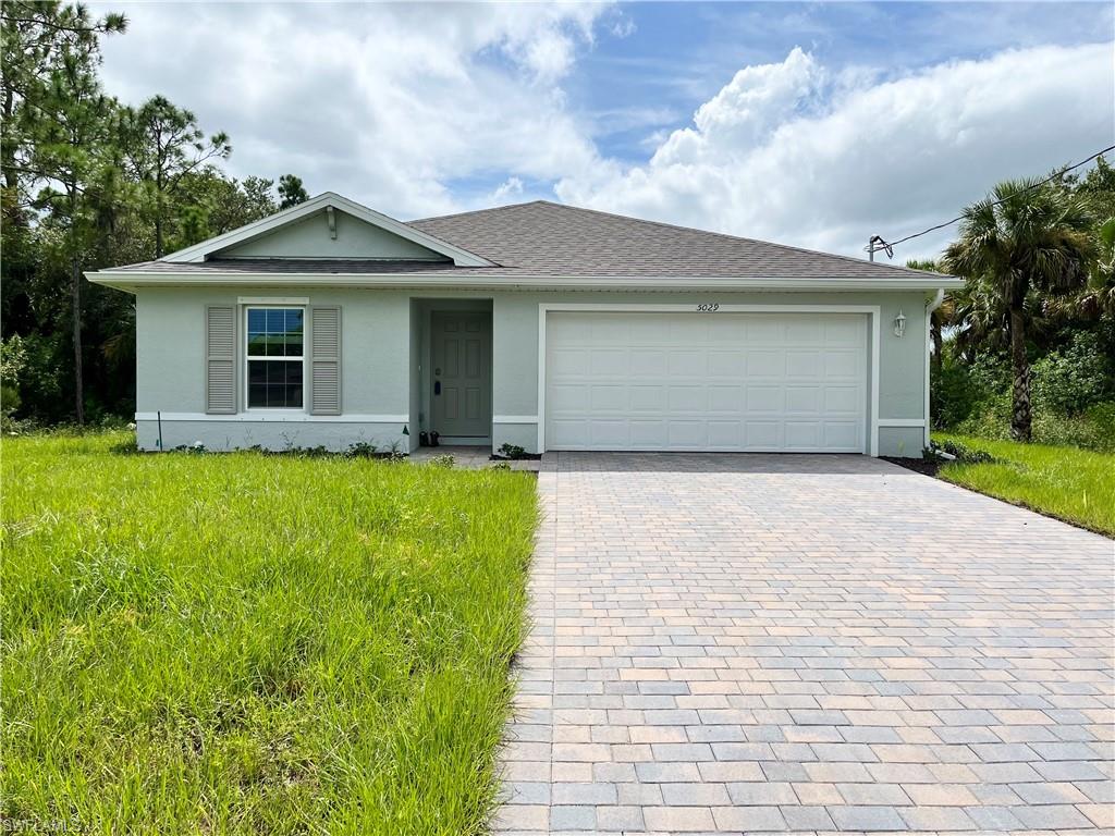 a front view of a house with a yard and garage