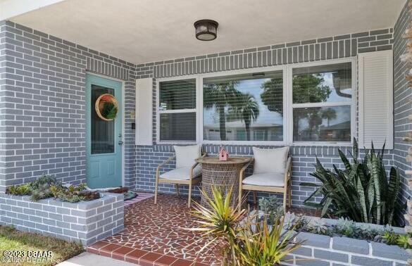 a front view of a house with outdoor seating and plants