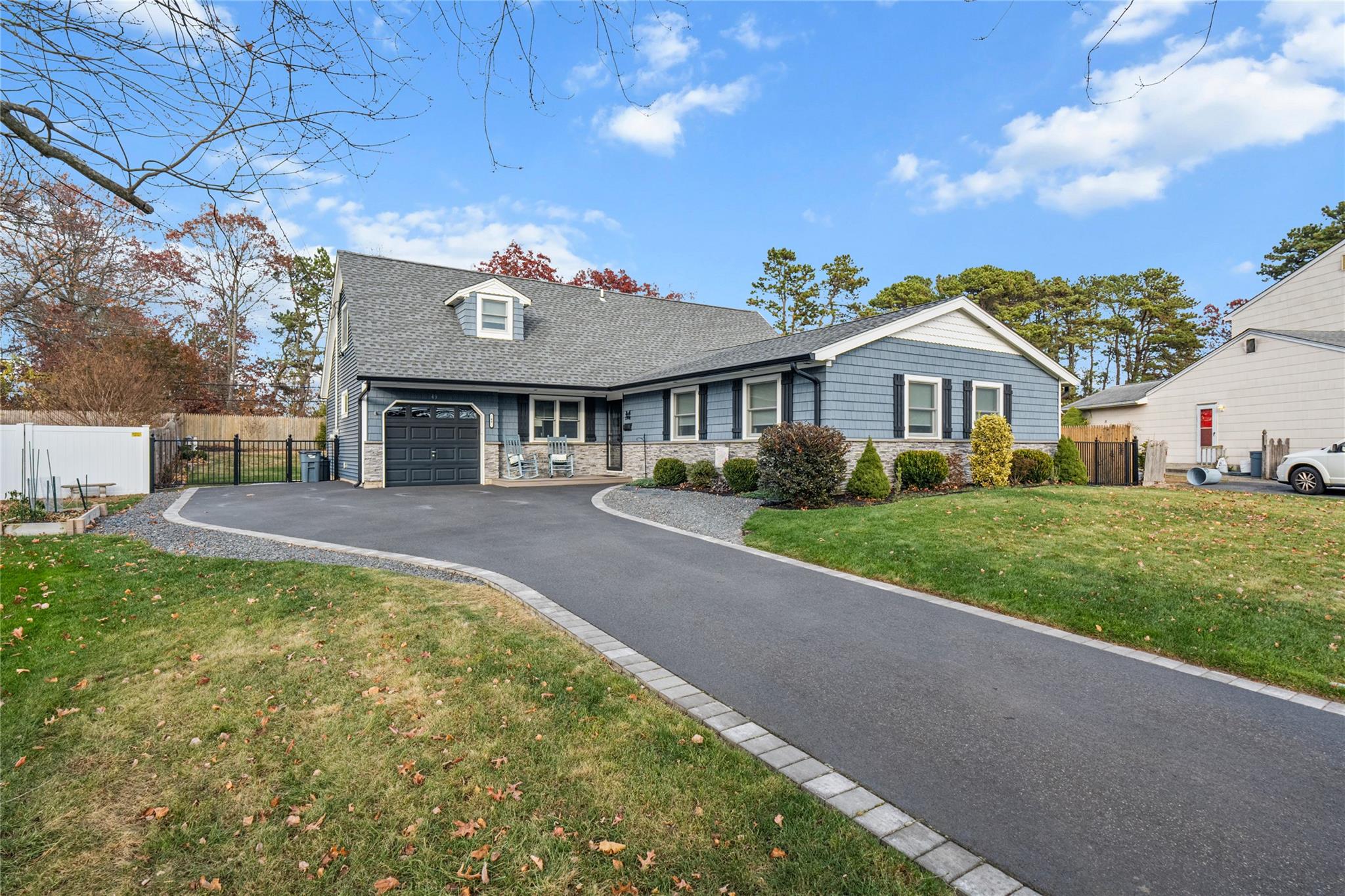 View of front of house with a garage and a front lawn