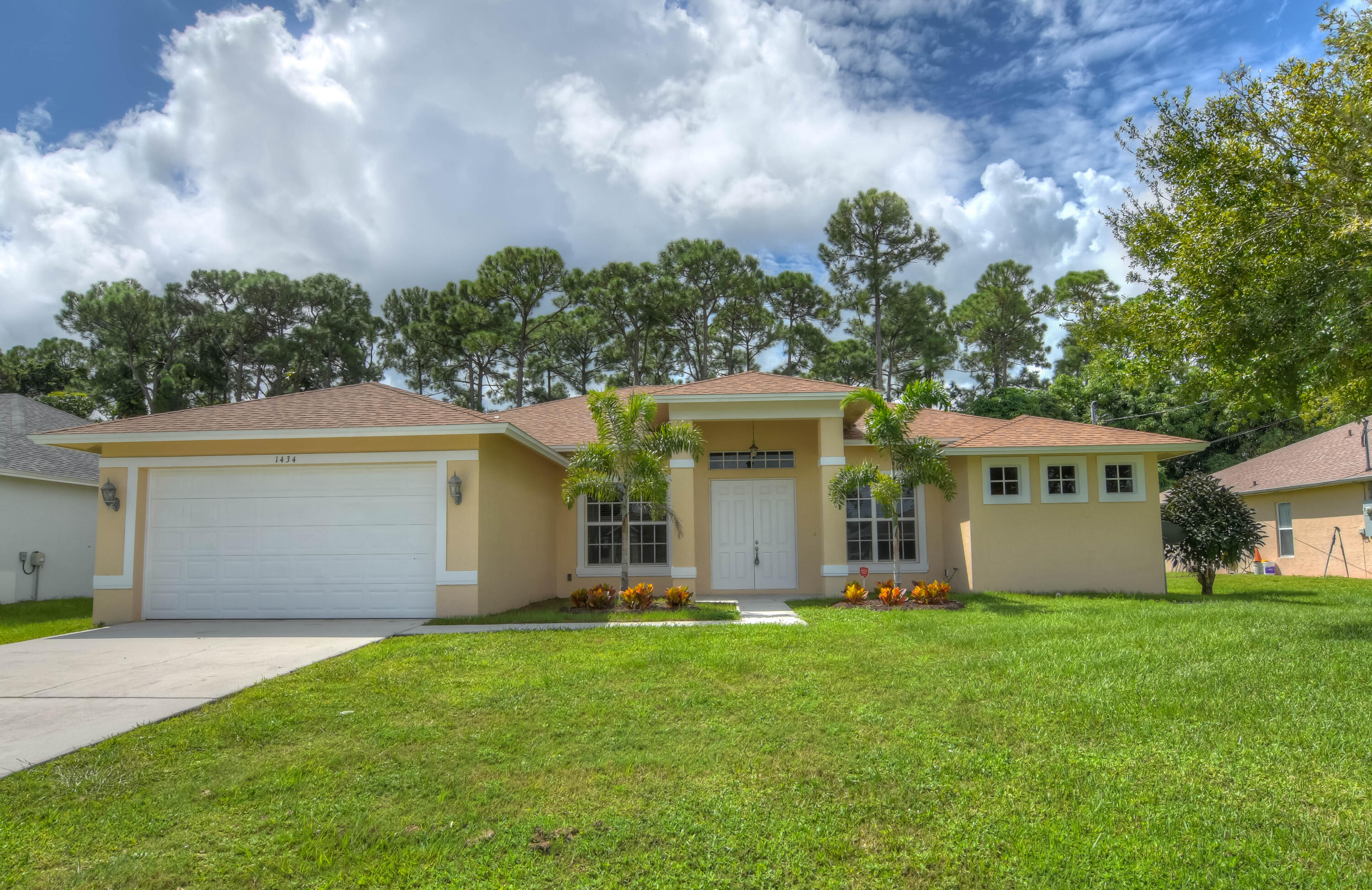 a front view of house with yard and green space