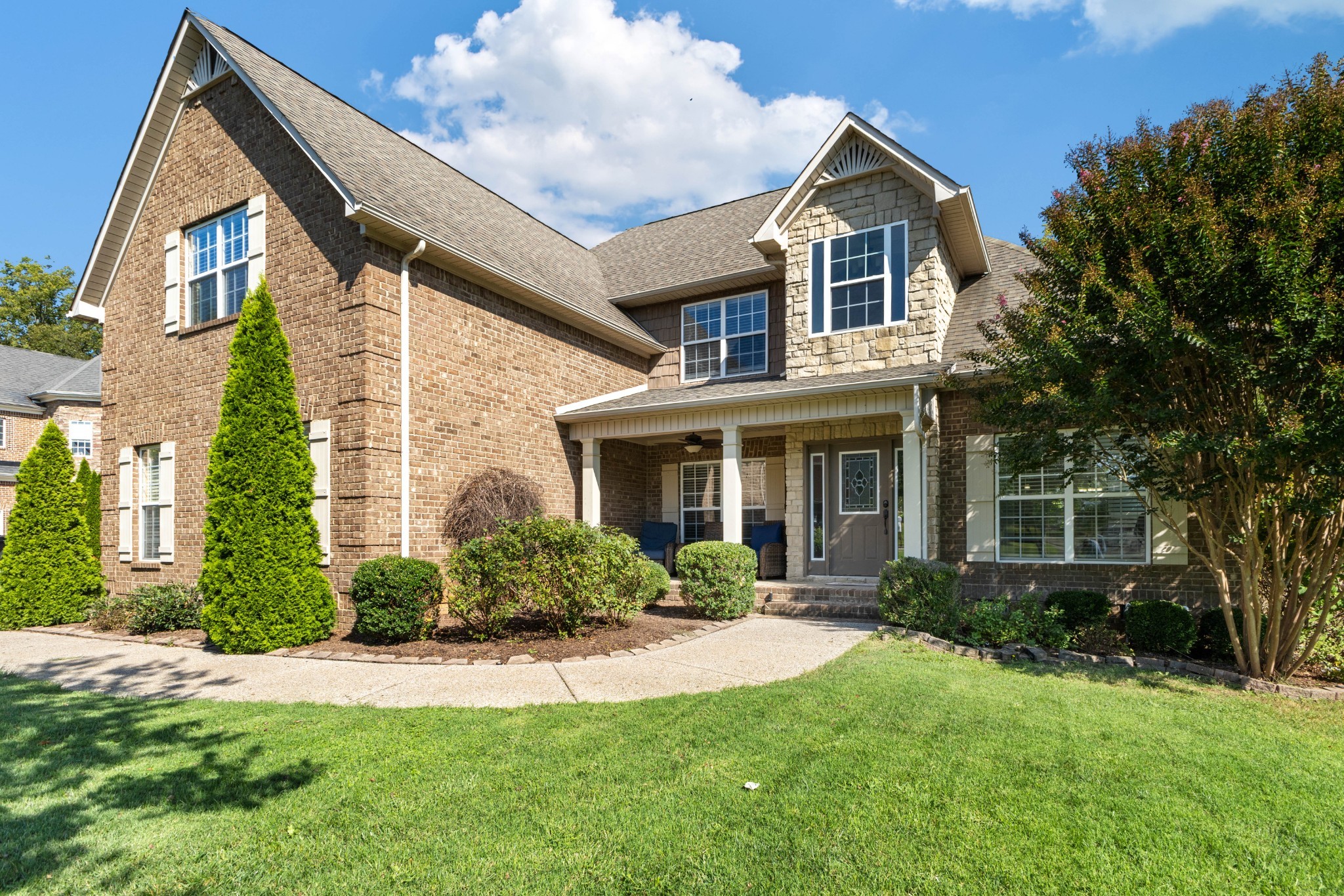 a front view of a house with a yard and porch