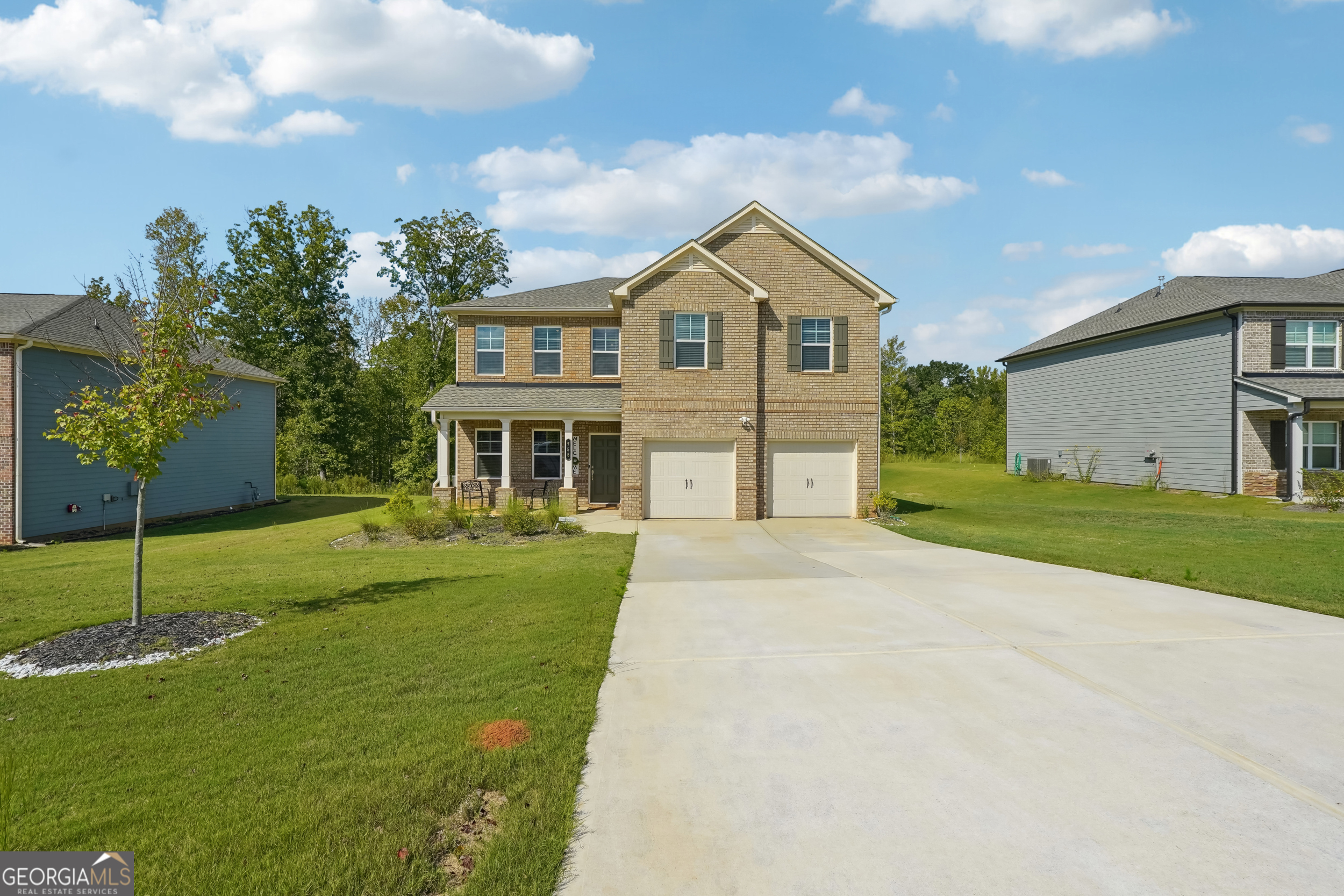 a front view of a house with a yard and garage