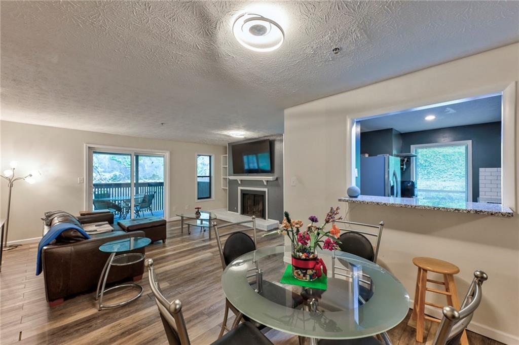 a living room with furniture kitchen and a large window