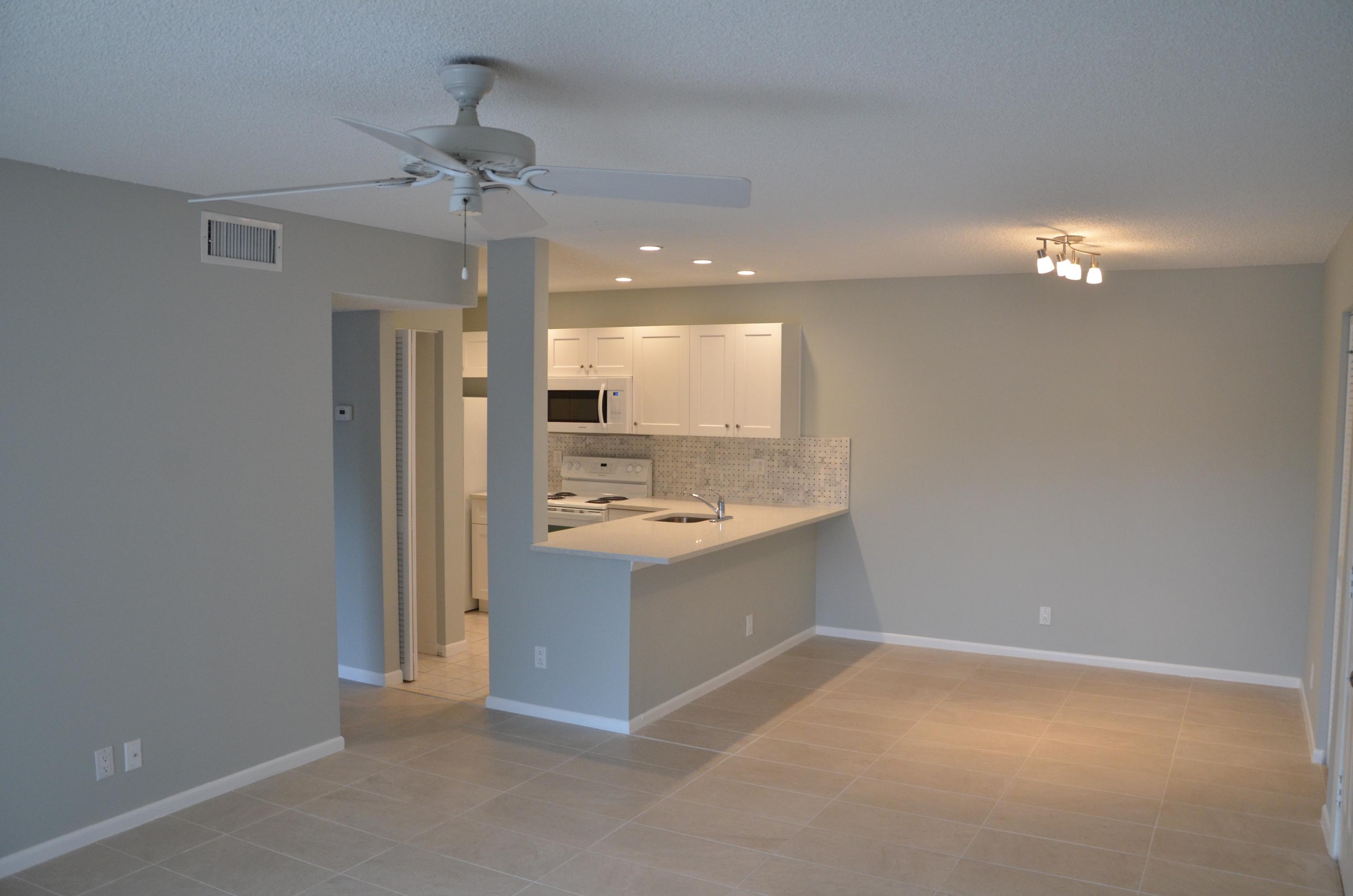 a view of a kitchen with a sink and cabinet with a yard