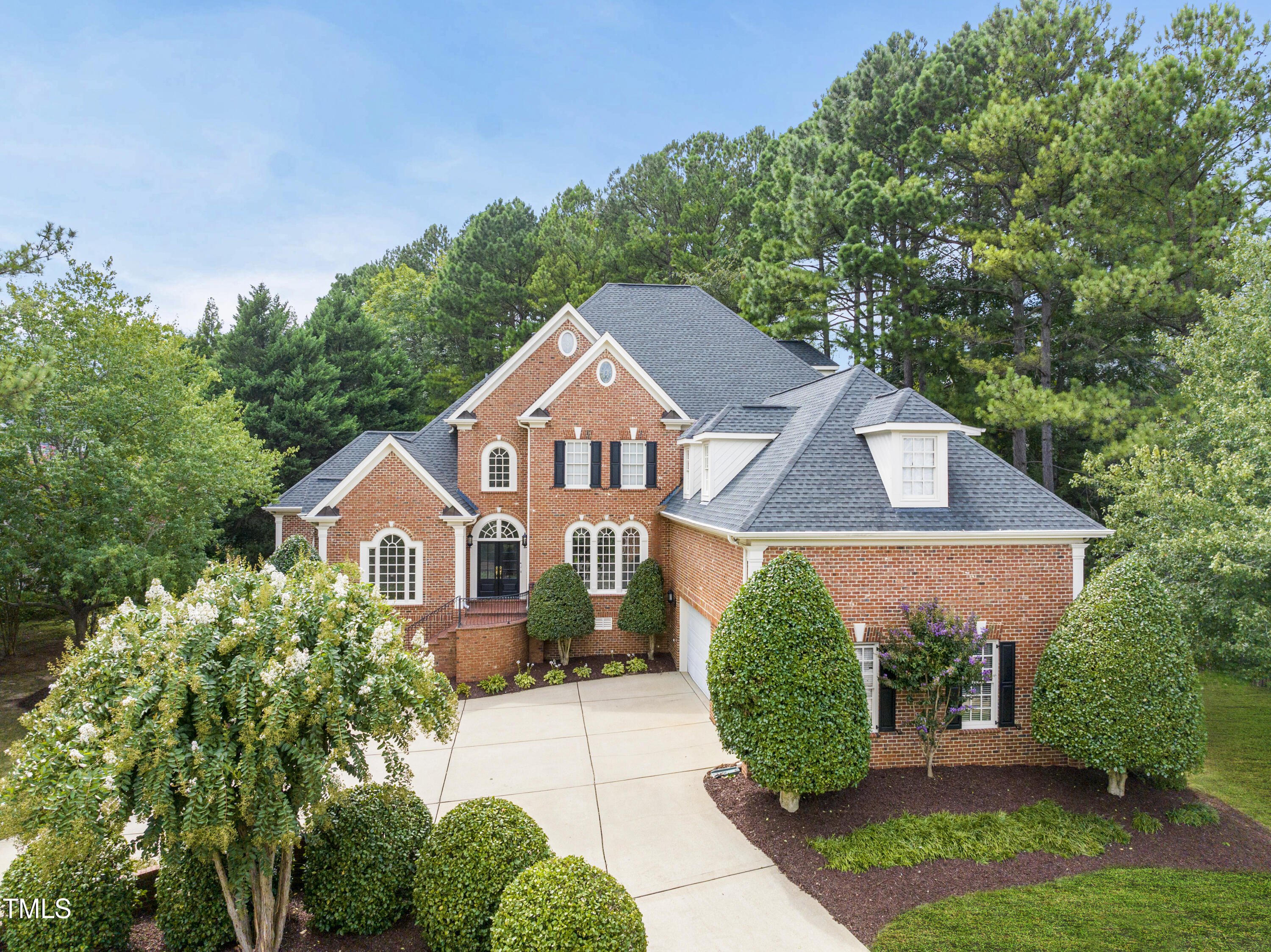 a aerial view of a house next to a yard