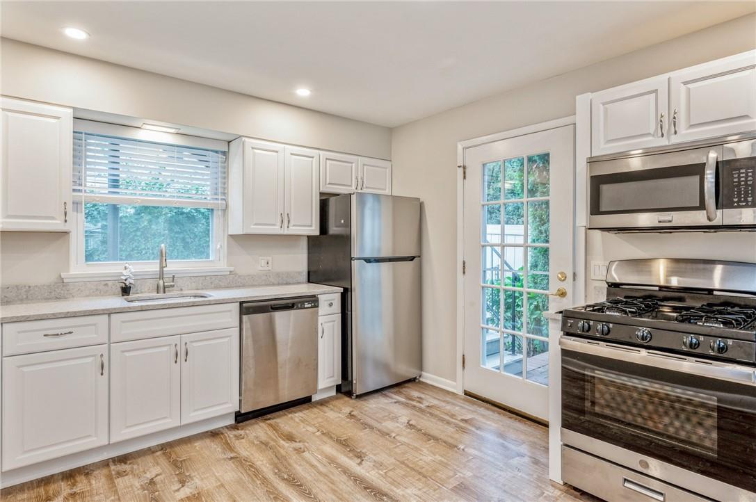 a kitchen with stainless steel appliances a refrigerator stove and sink