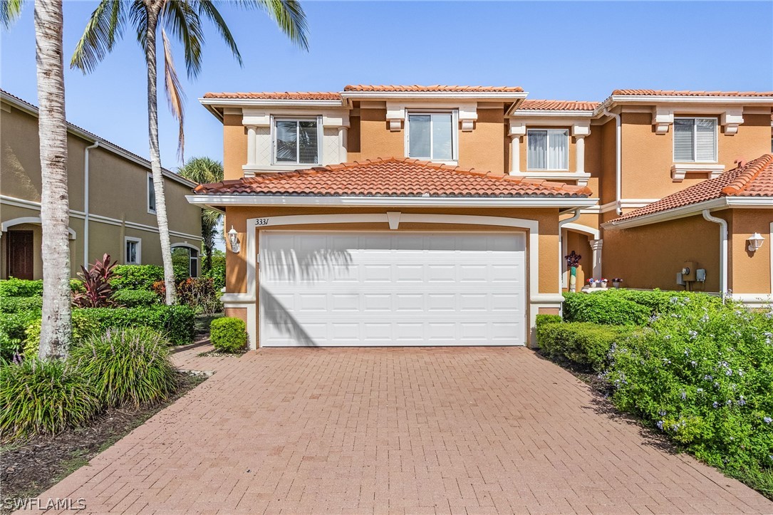 a front view of a house with a yard and garage