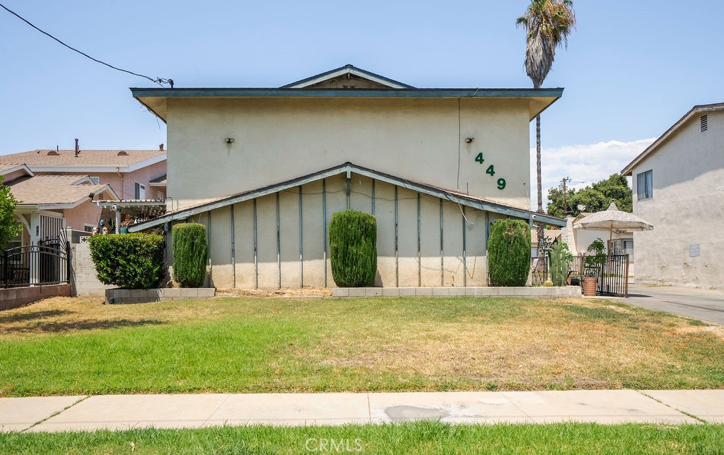 a view of a house with a yard and sitting area