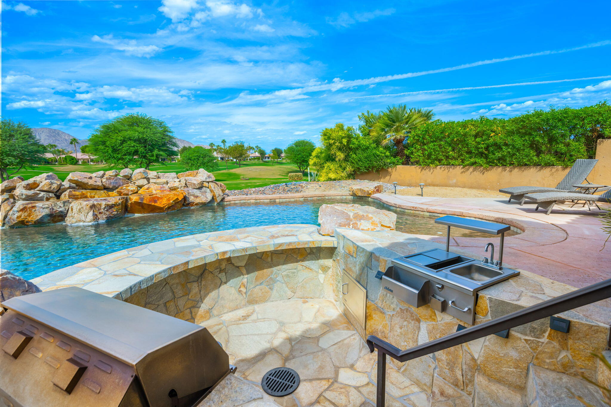 swimming pool view with a seating space