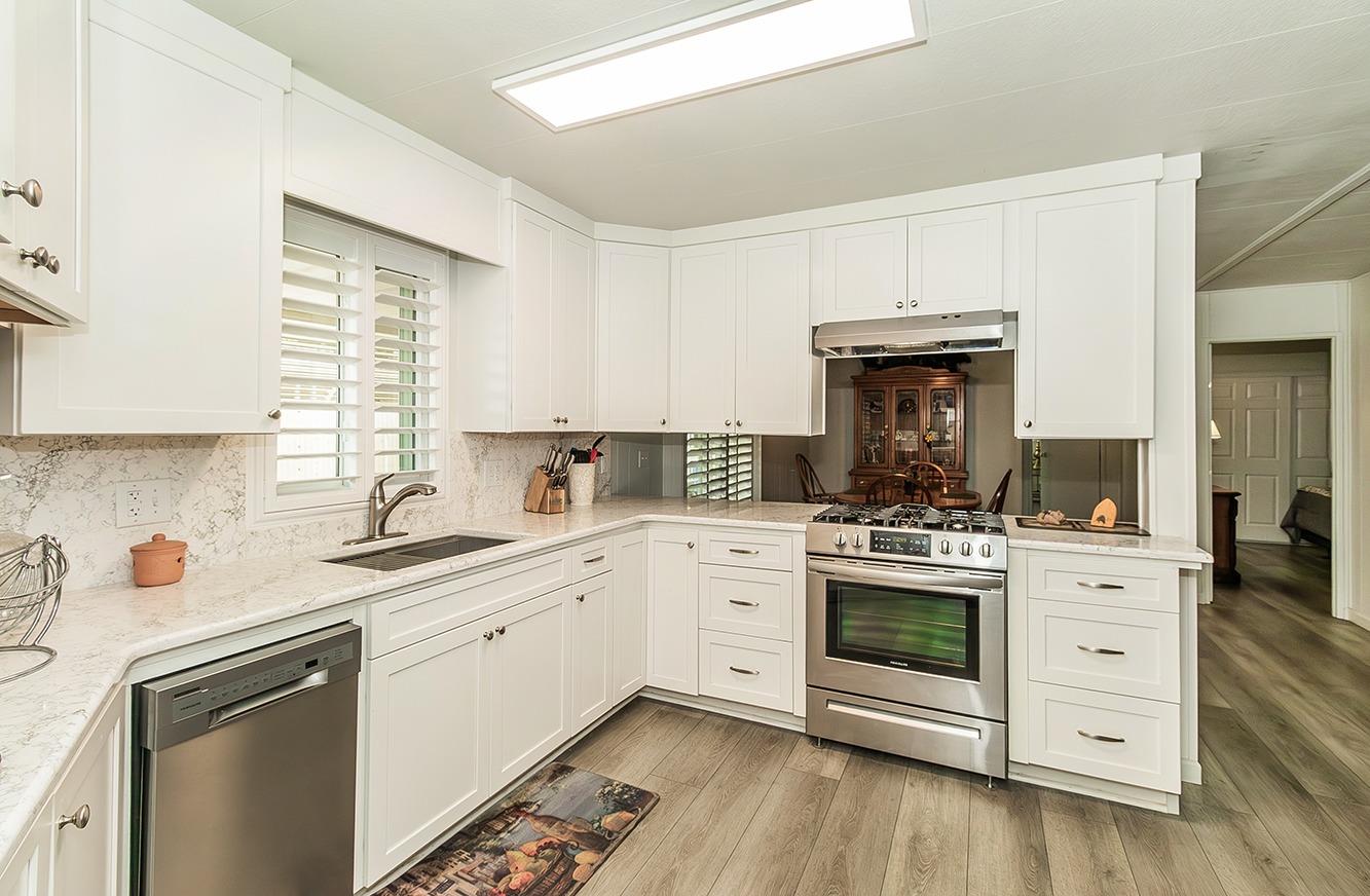 a kitchen with a stove oven and sink