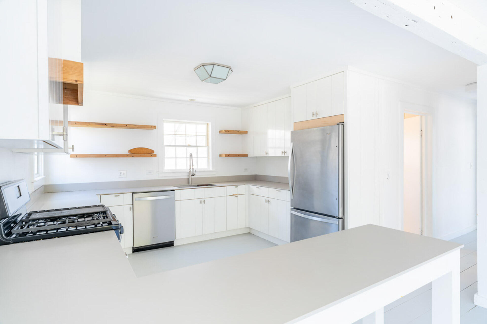 a kitchen with granite countertop a refrigerator and a sink