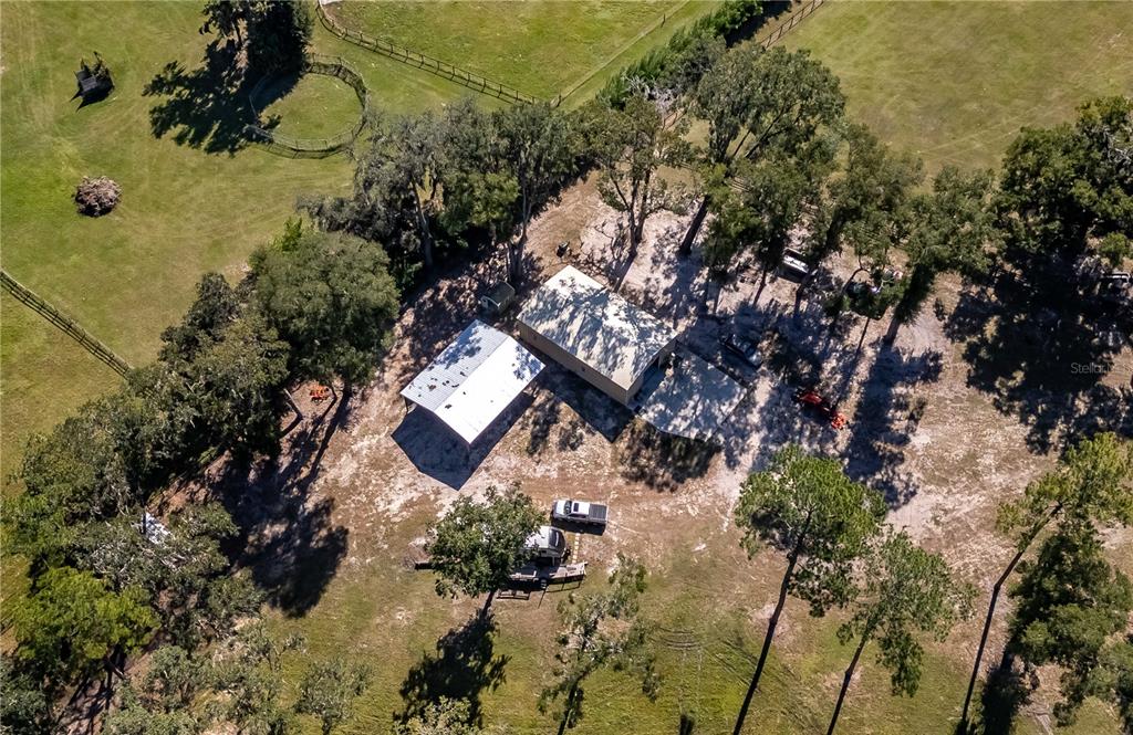 an aerial view of a house with yard