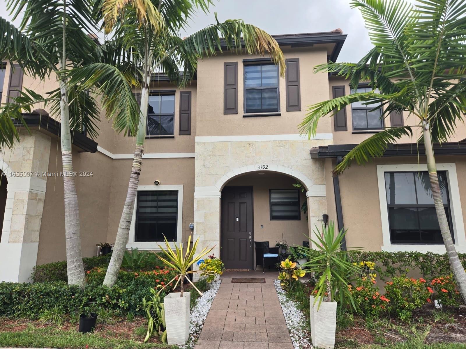 a front view of a house with a garden