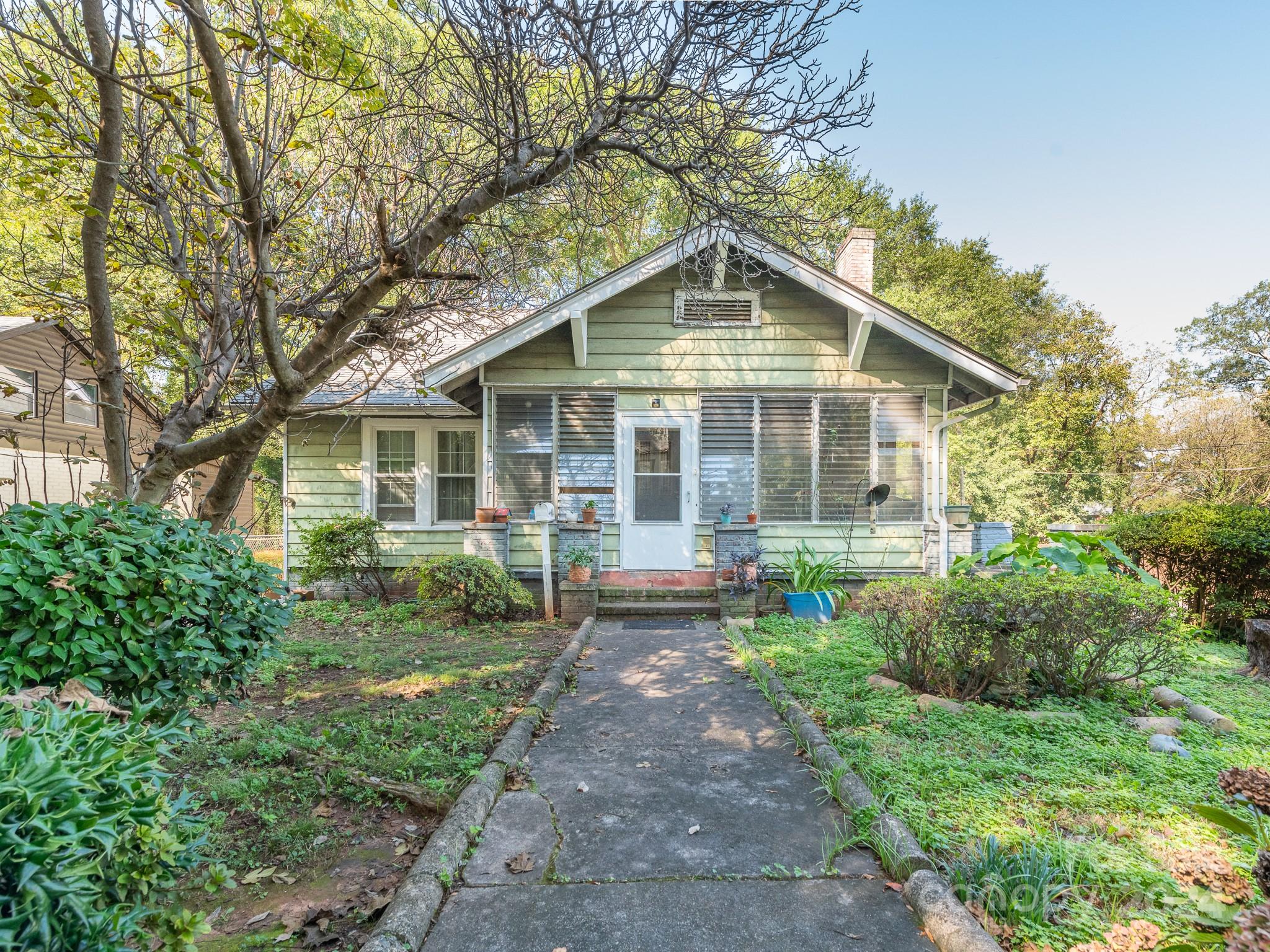 a front view of a house with yard and green space