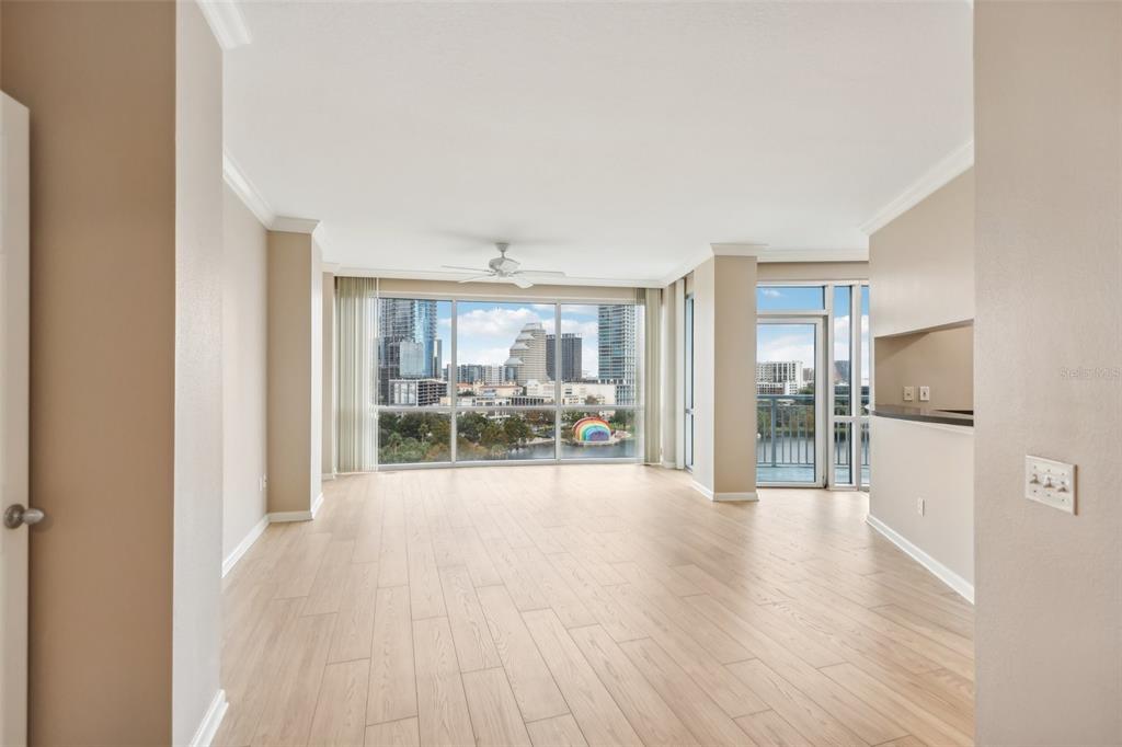 a view of a livingroom with wooden floor and furniture