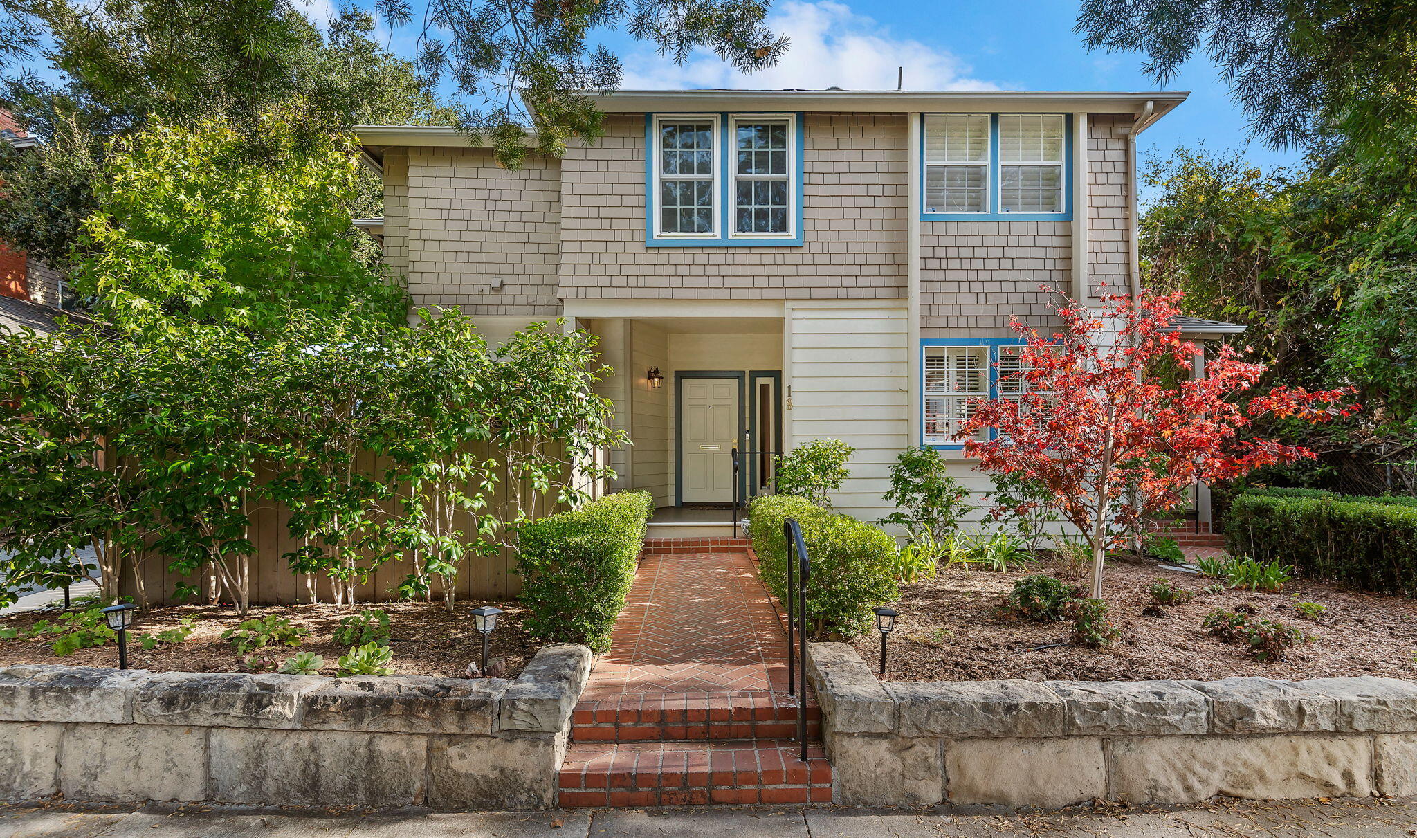 a front view of a house with garden