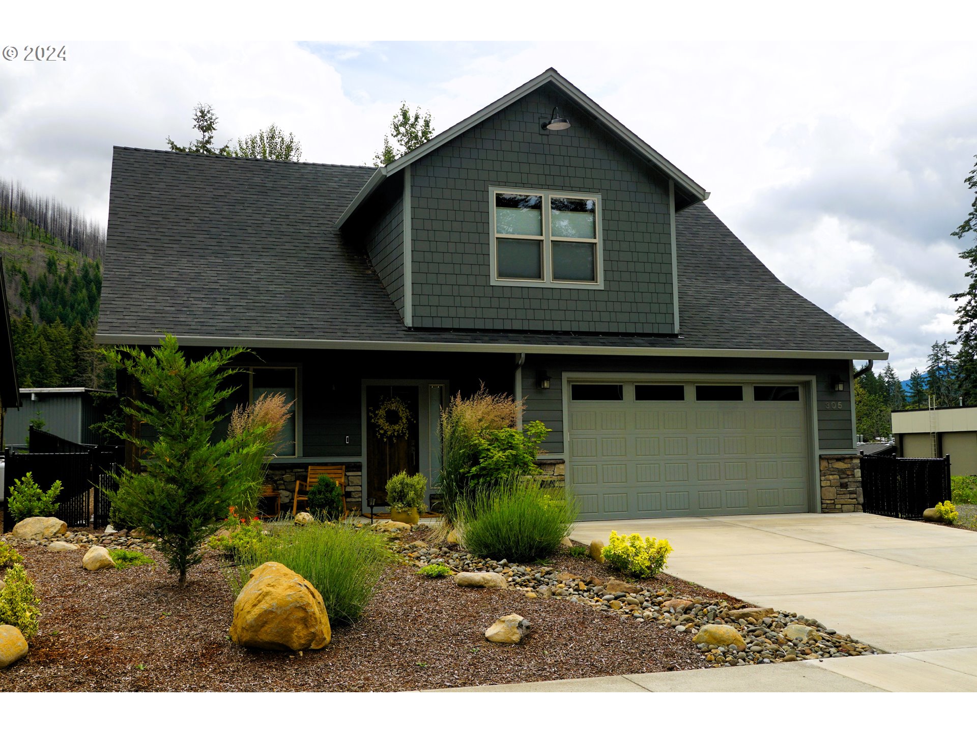 a front view of a house with garden