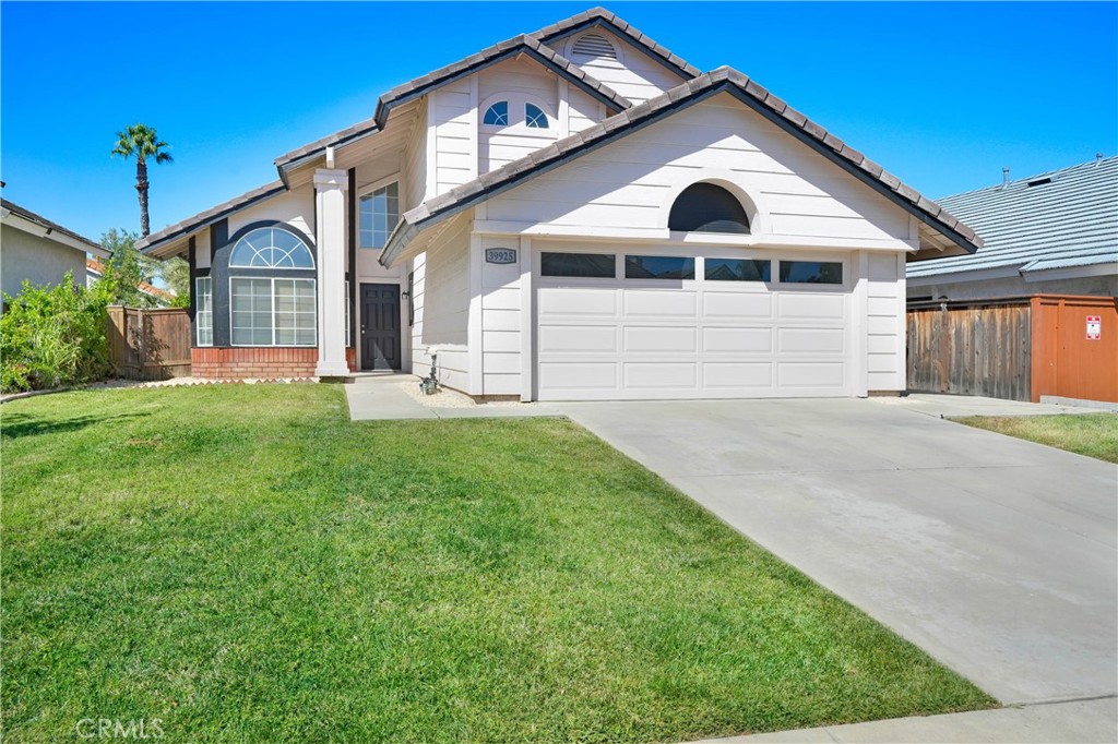 a view of a house with a yard and garage