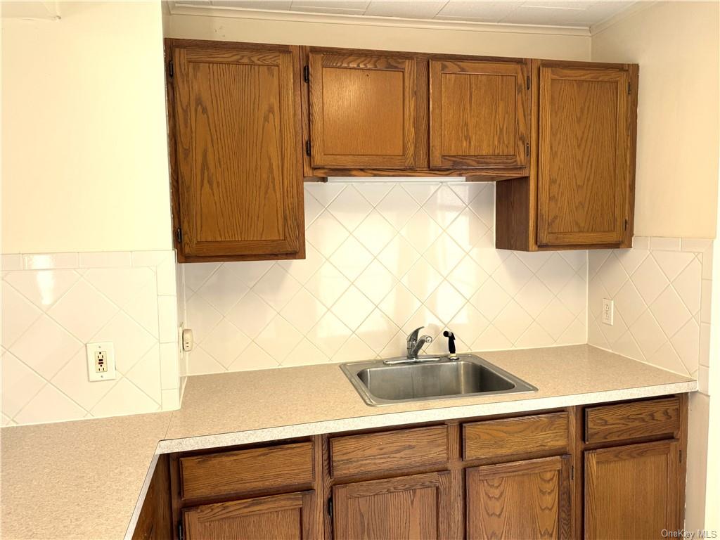 a kitchen with a sink cabinets and appliances