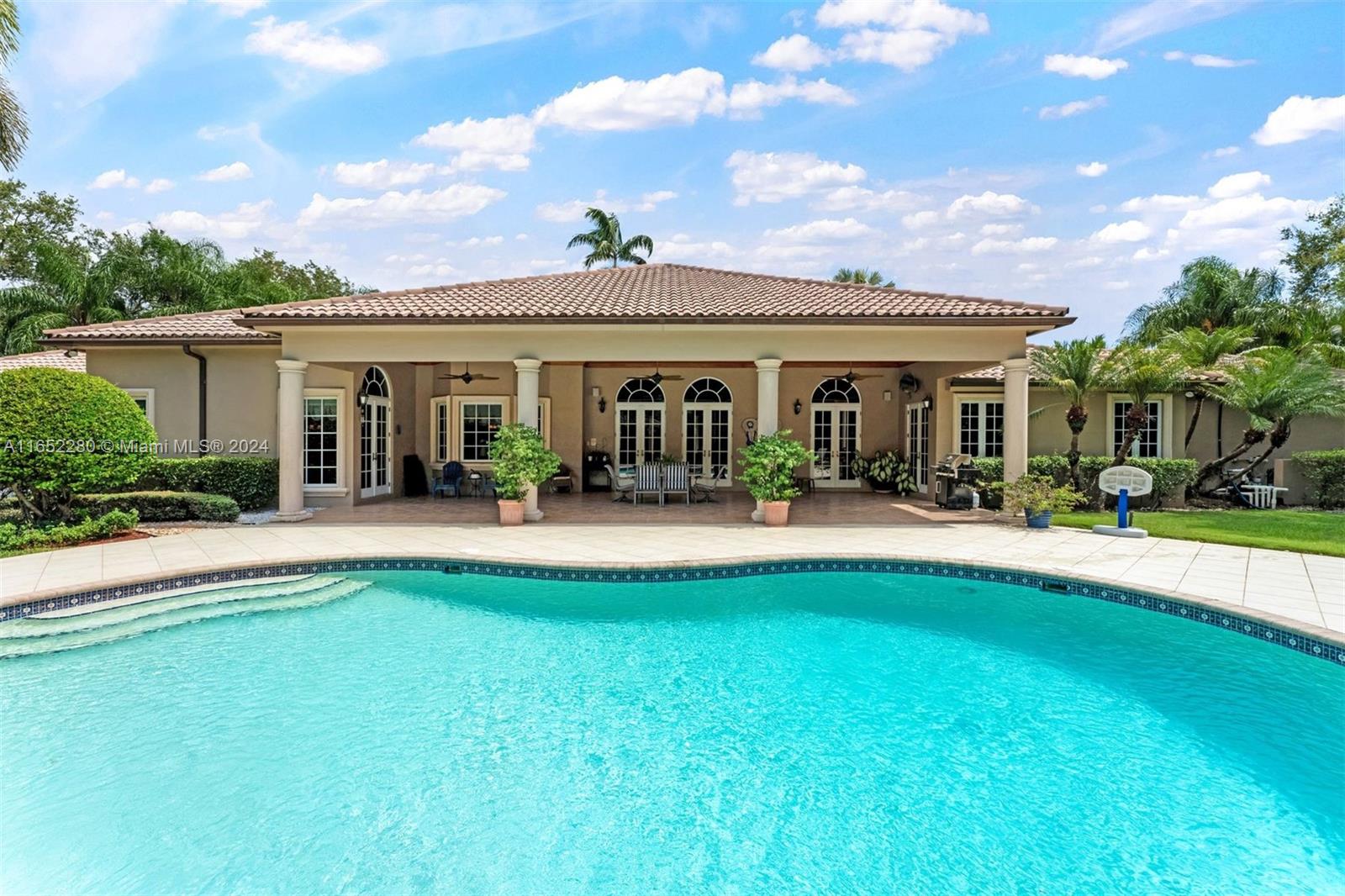 a view of a house with swimming pool and a yard