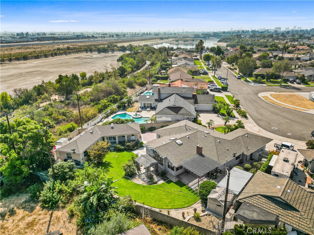 an aerial view of residential houses with outdoor space and swimming pool