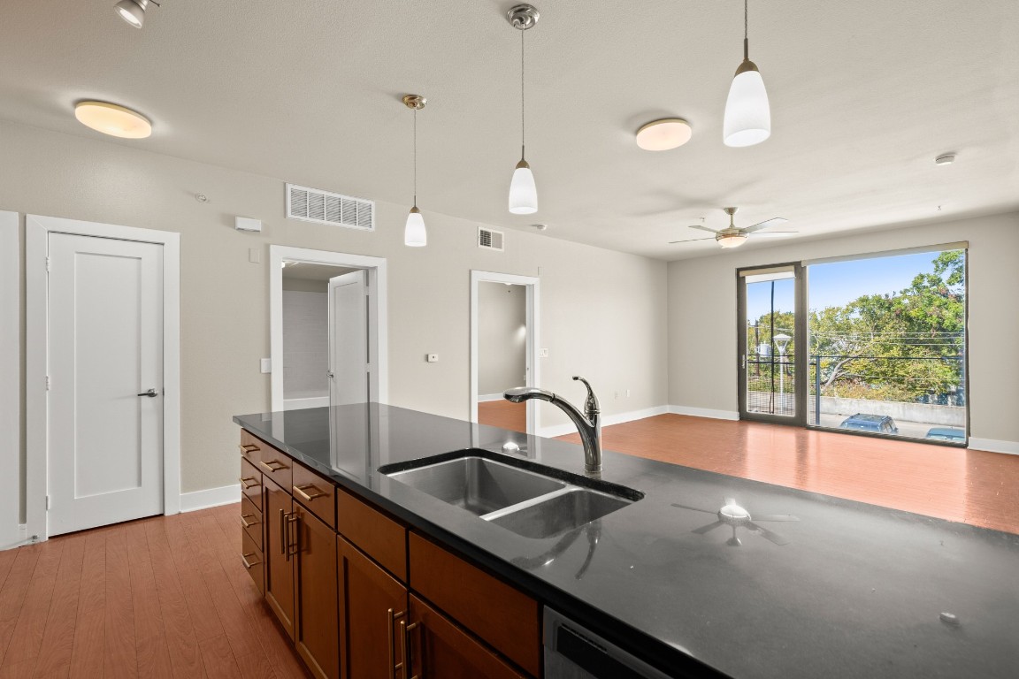 a kitchen with granite countertop a sink and a window