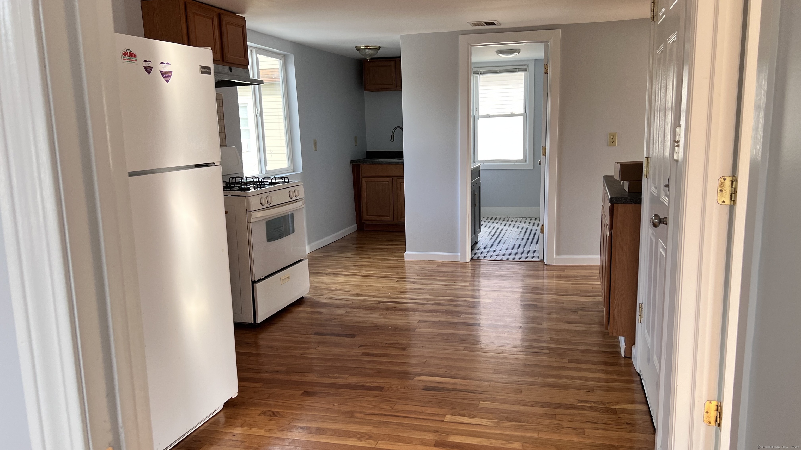 a view of hallway with wooden floor