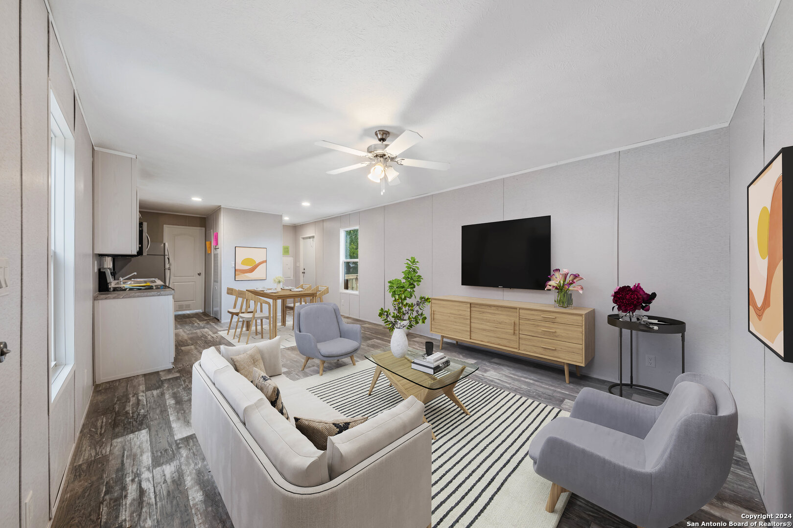 a living room with furniture and a flat screen tv