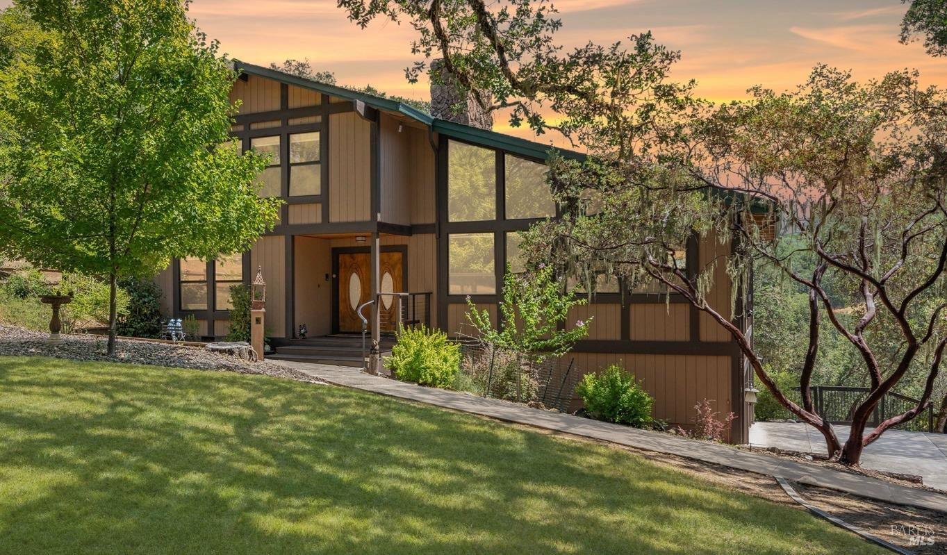 front view of a house with a tree in the yard