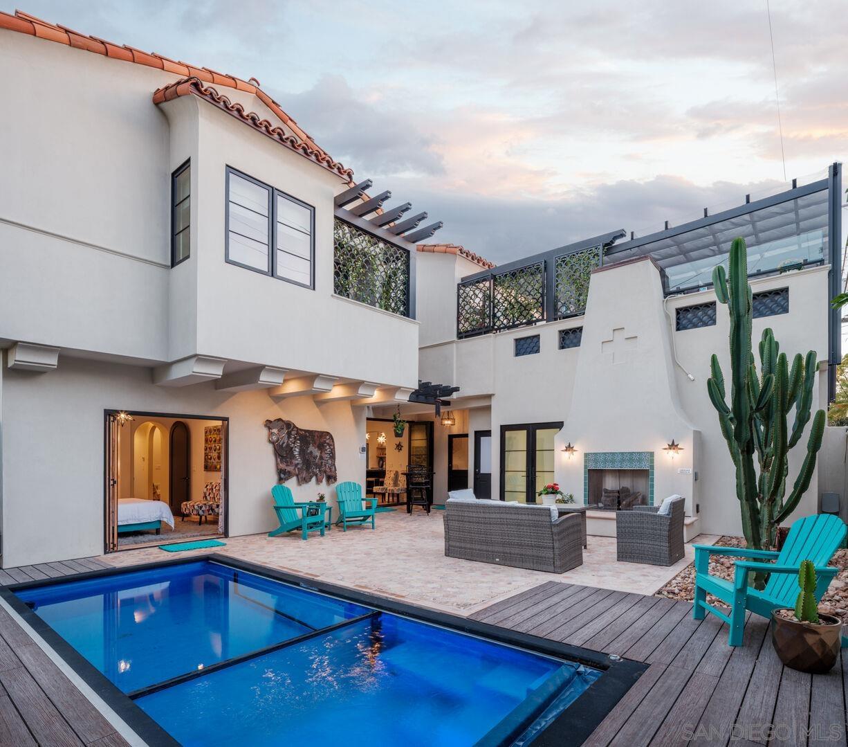 a view of a house with pool and sitting area