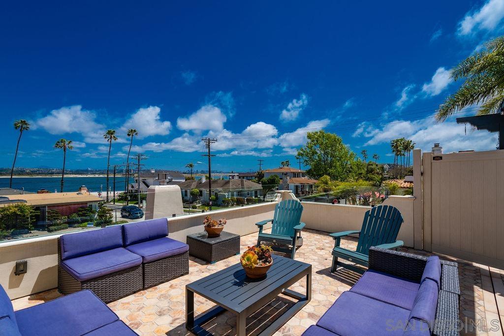 a roof deck with table and chairs a barbeque and potted plants