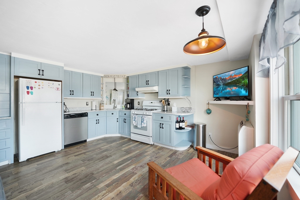 a open kitchen with stainless steel appliances granite countertop a stove refrigerator and cabinets