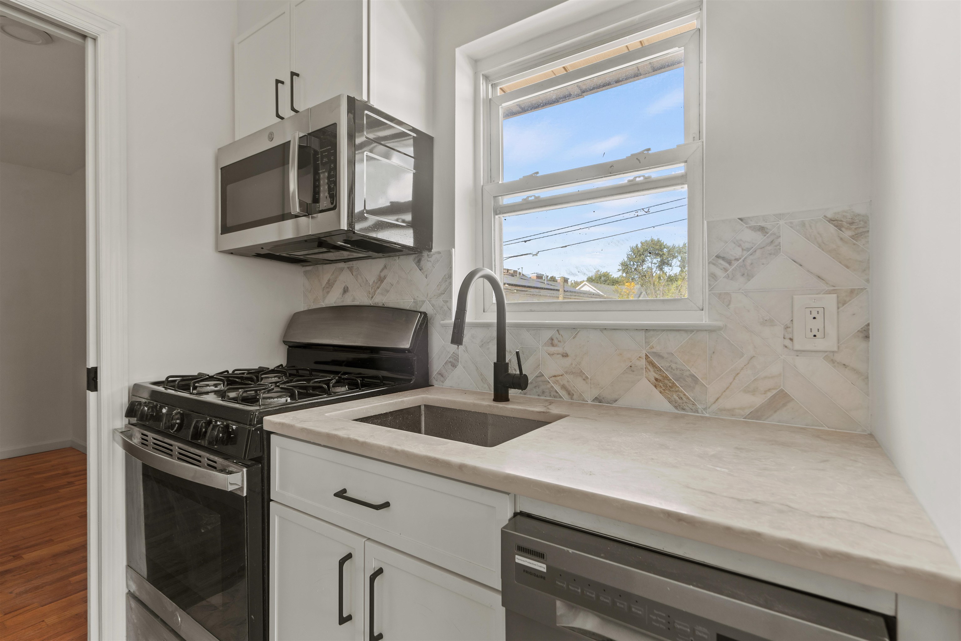 a kitchen with stainless steel appliances a stove and a microwave