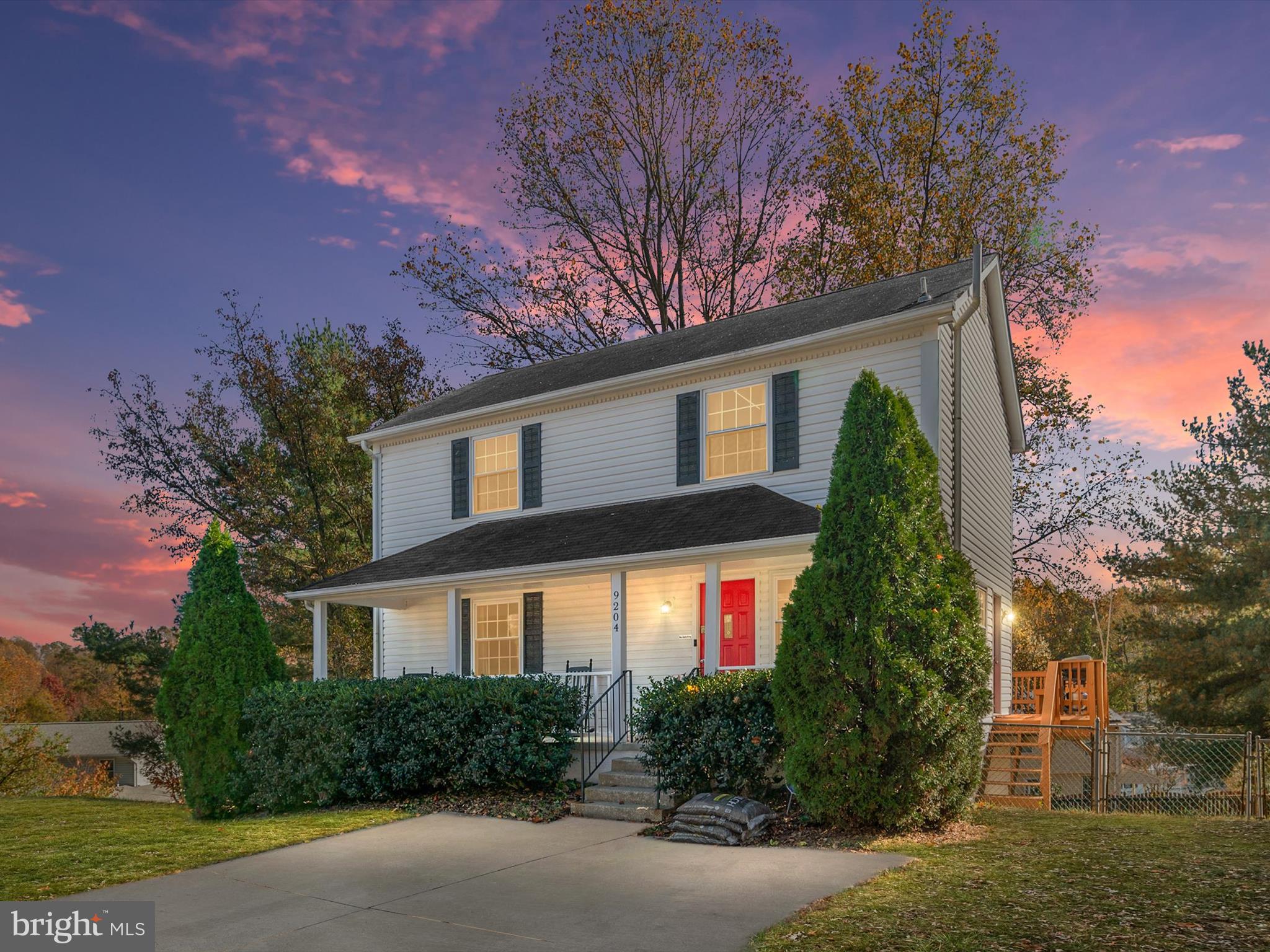 a front view of a house with a yard and outdoor seating