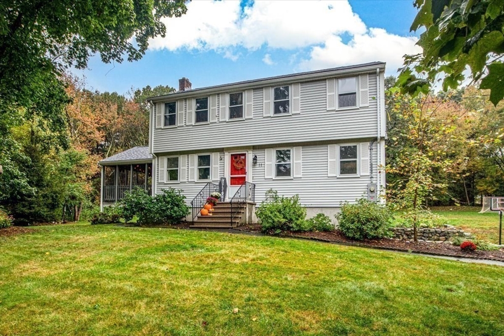 a front view of house with yard and green space