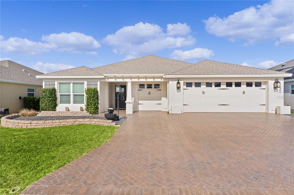 STUNNING 3/3 INDIGO DESIGNER WITH PAVERED BRICK DRIVE AND WALKWAY, PERGOLA ENTRANCE, 2 CAR+ GOLF CART GARAGE LOCATED IN THE VILLAGE OF BRADFORD.