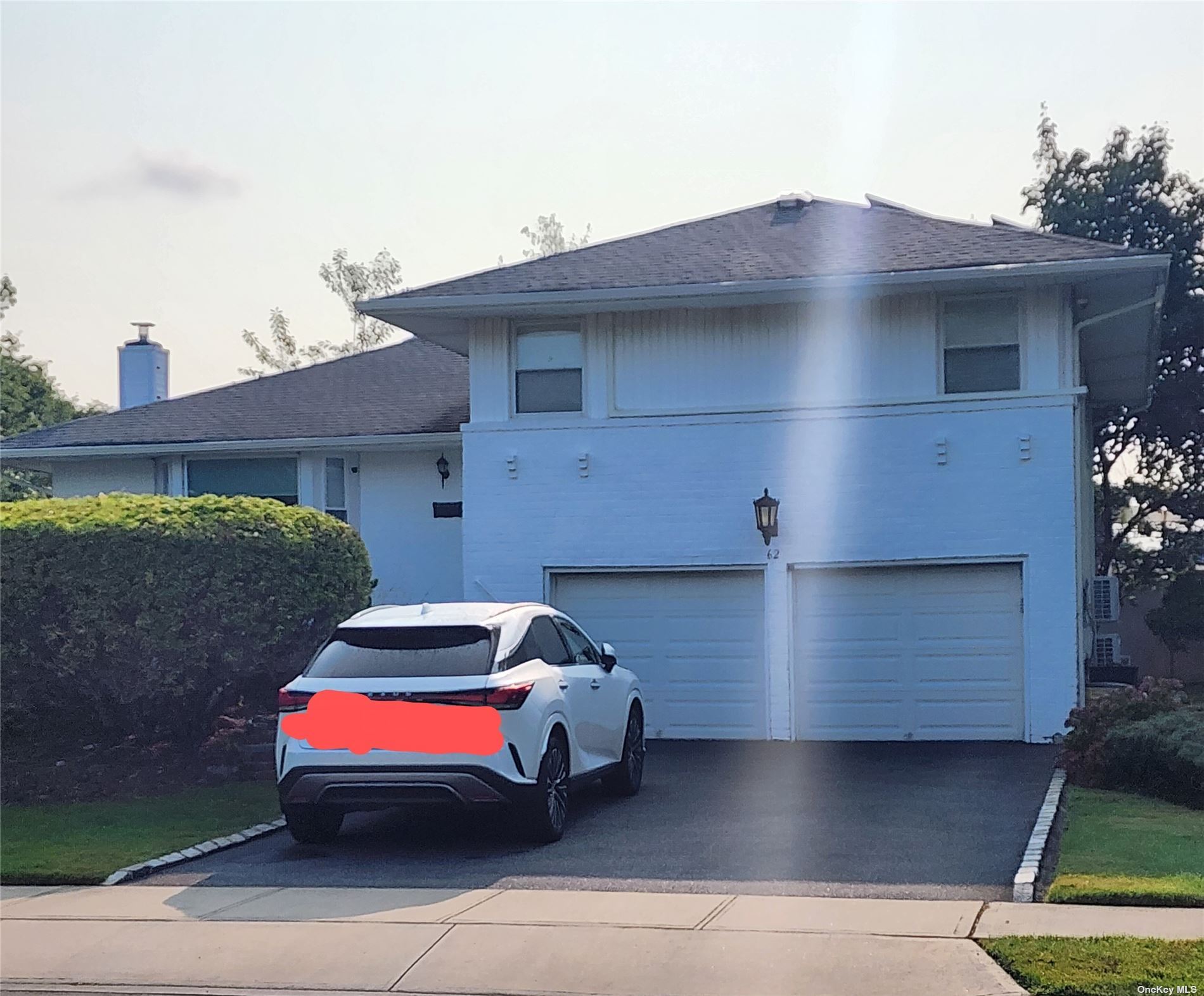 a front view of a house with parking space