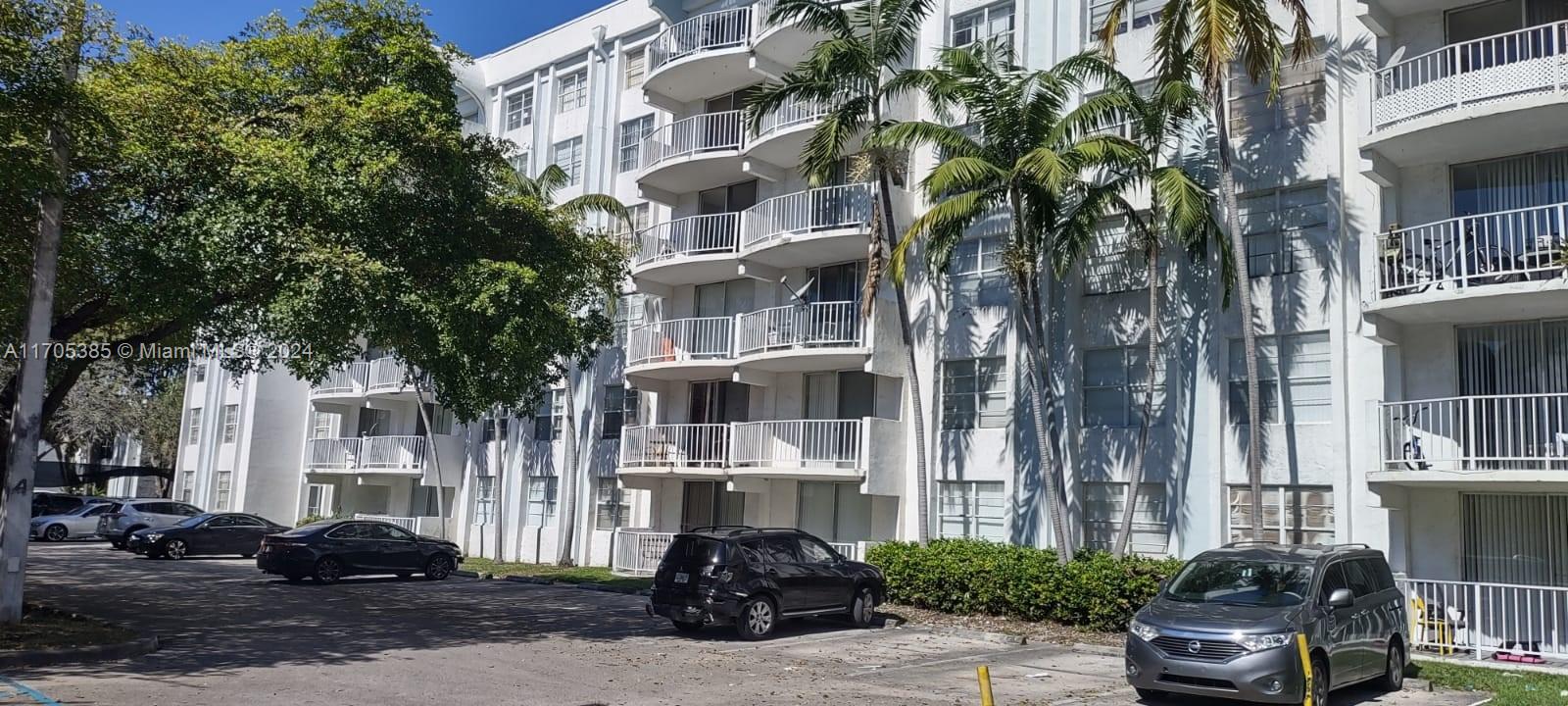 a couple of cars parked in front of a building