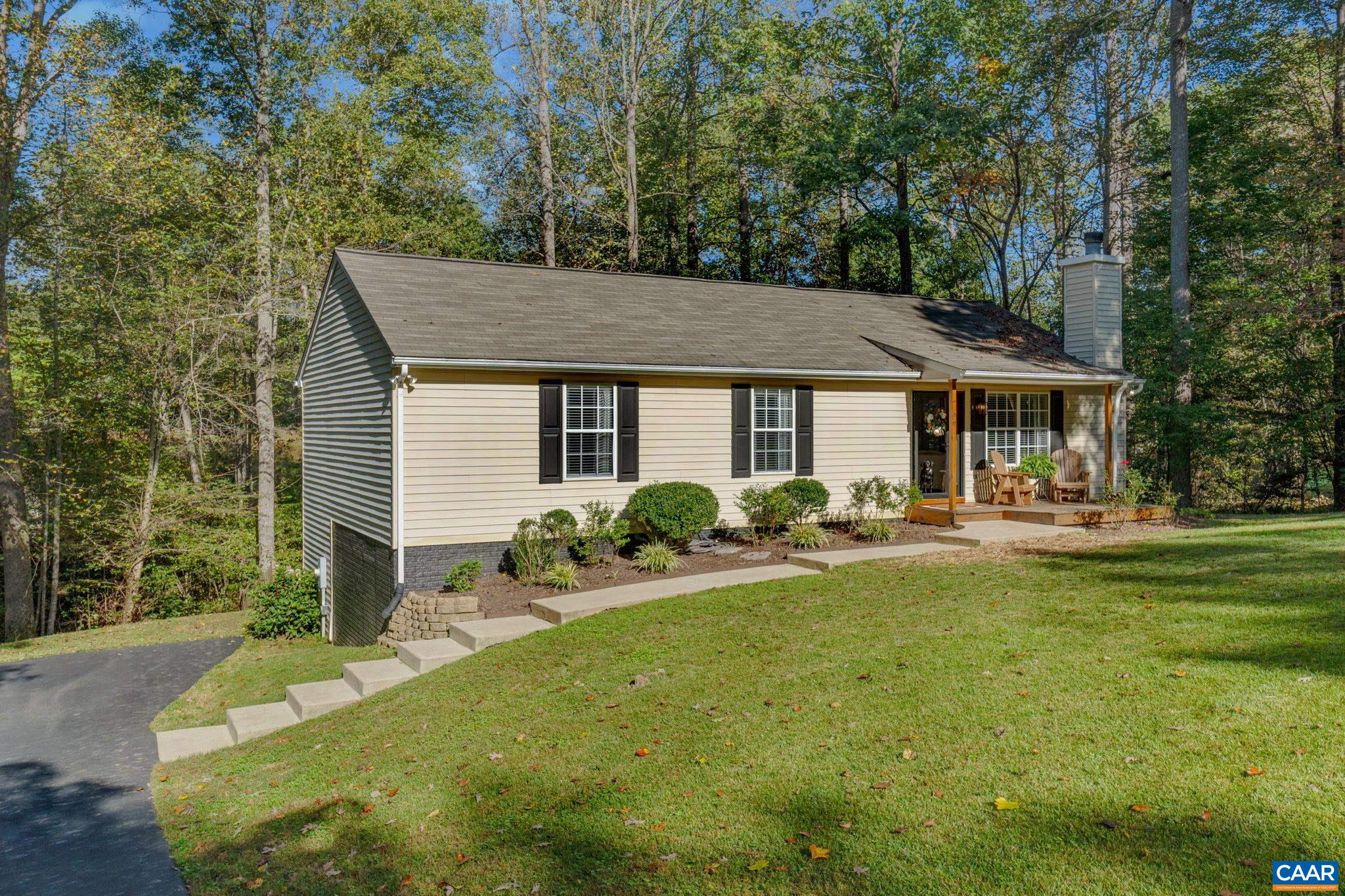 a view of a house with backyard sitting area and garden