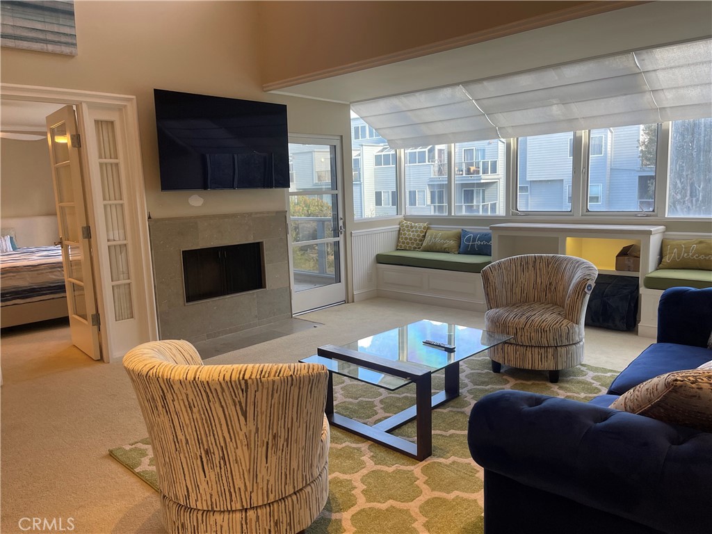 a living room with furniture a flat screen tv and a fireplace