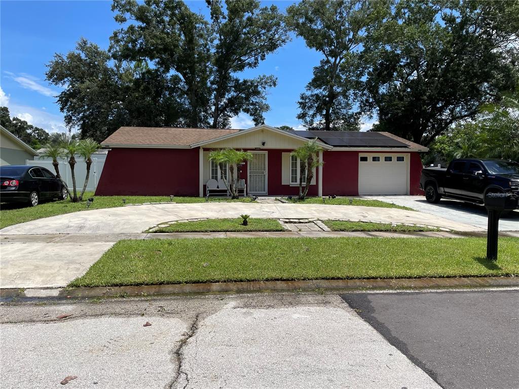 a front view of house with yard and green space