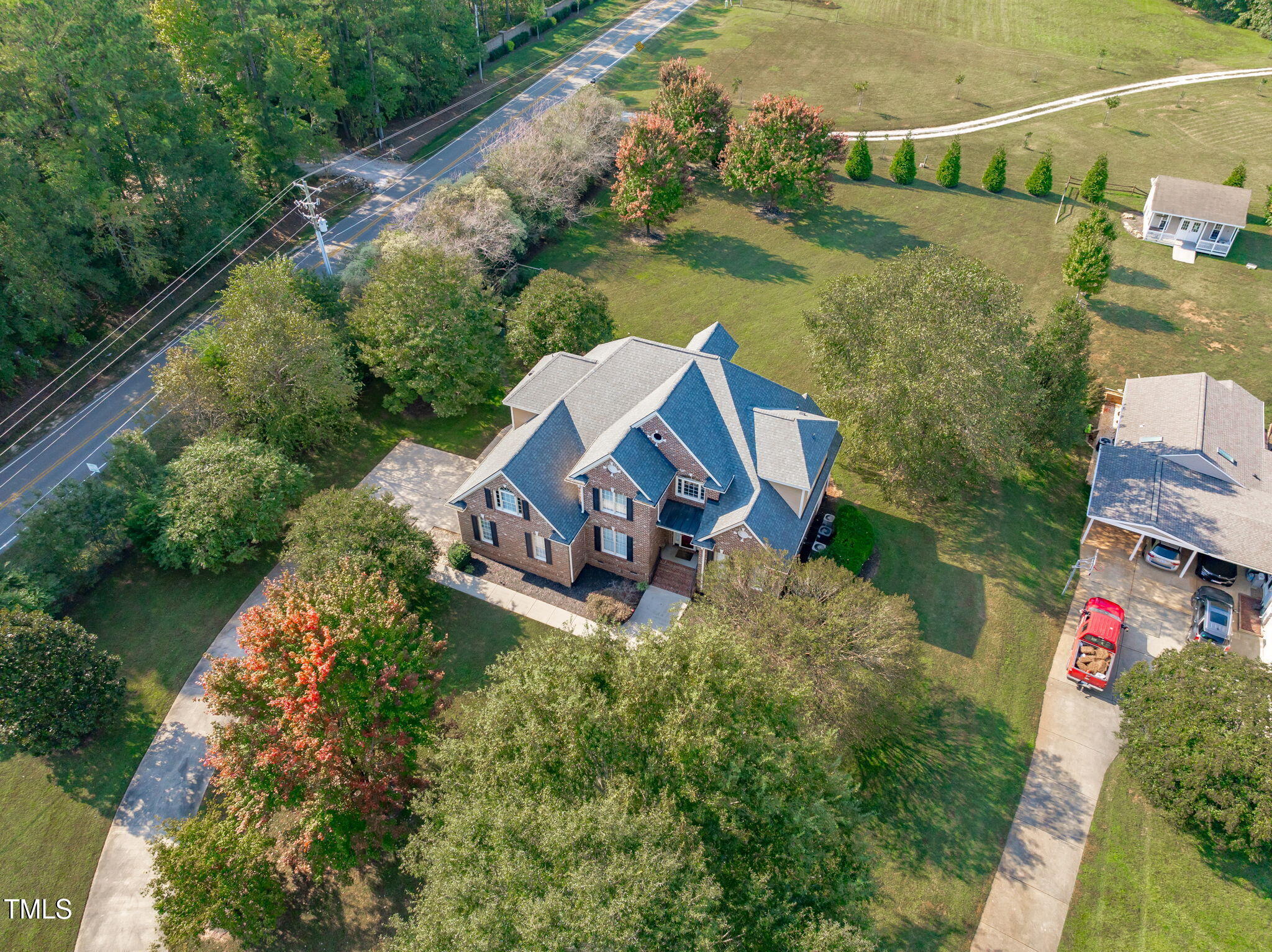 an aerial view of a house with outdoor space and a lake view