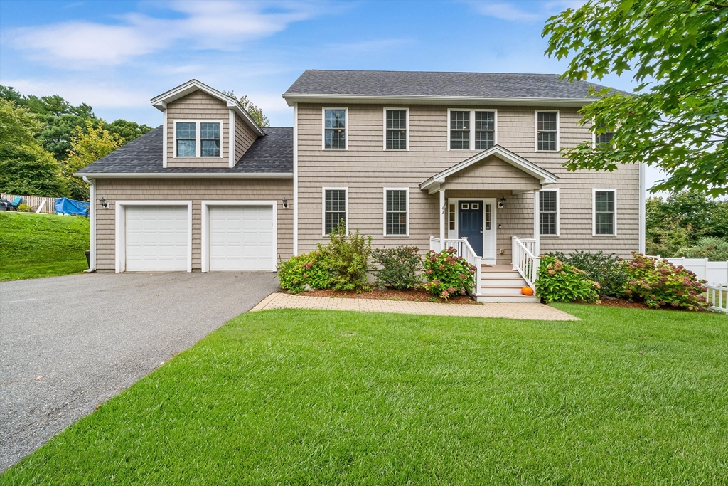 a front view of a house with a yard and garage