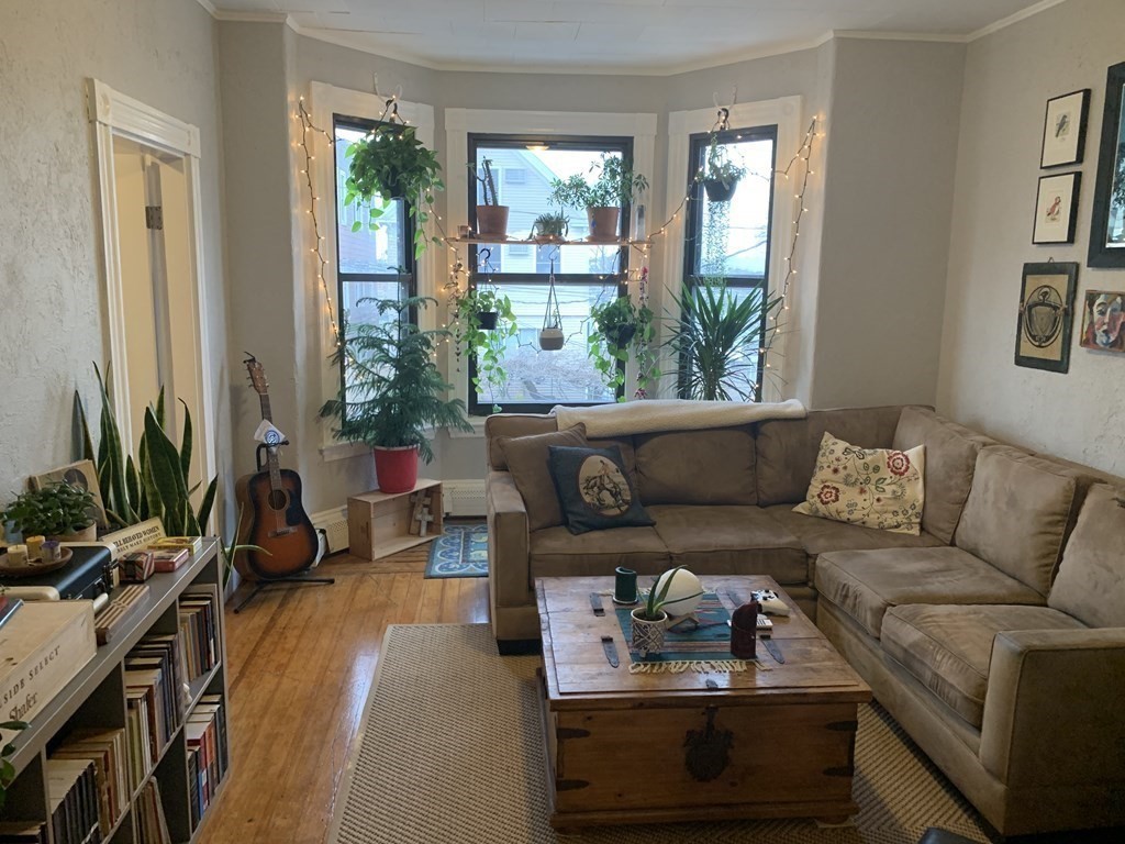 a living room with furniture and a large window